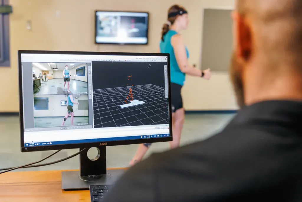 A professor looks at a monitor that displays motion information based on a student's movements