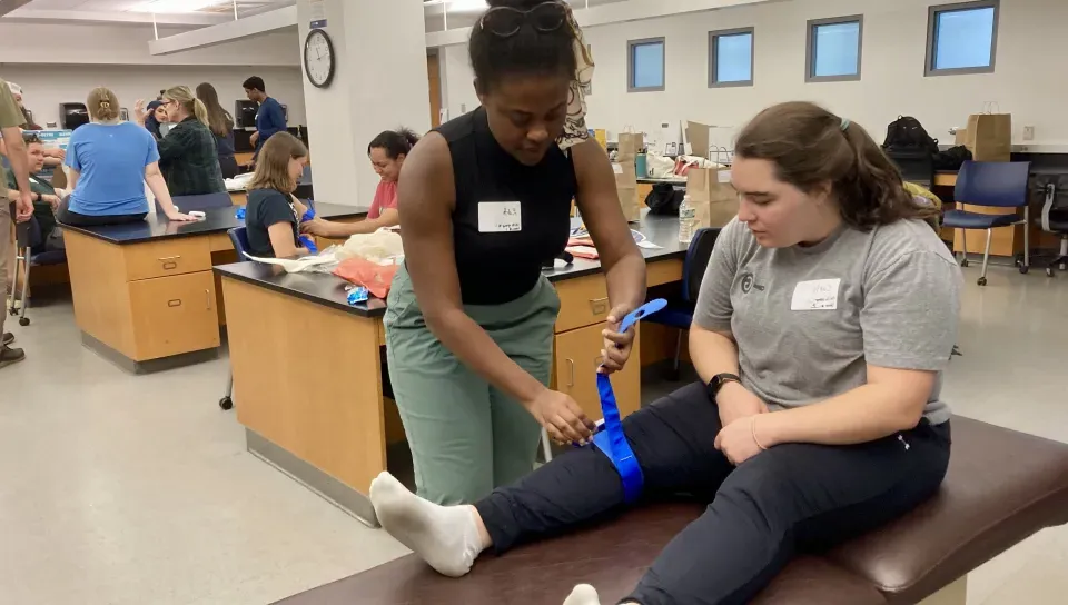 UNE students learn splints at a training station. 